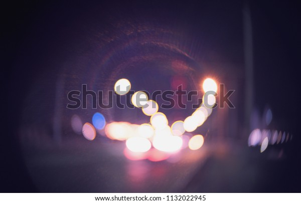 Defocused street with\
lamps in the night