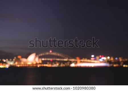 defocused Sydney harbour bridge and operahouse, light night bokeh idea for background. 