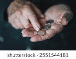 Defocused view to elderly woman counts metal coins, wrinkled female hands close up. Concept of poverty, pension payments, retiree with money. poverty pensioners. old women