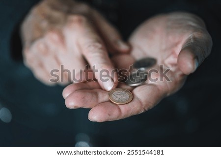 Defocused view to elderly woman counts metal coins, wrinkled female hands close up. Concept of poverty, pension payments, retiree with money. poverty pensioners. old women's hands count coins.