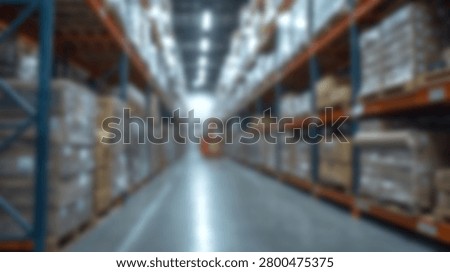A defocused view looking down the central aisle of a spacious modern distribution warehouse with tall storage racks
