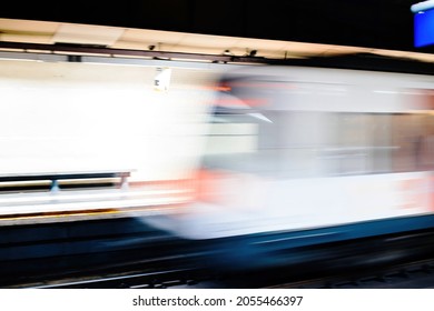 Defocused View Of Metro Train Arrival In Station Platform With No People - Light Trails Fast On Time Public Transportation