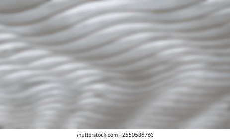 A defocused view of wavy patterns. It has a soft, undulating appearance with a monochromatic color scheme, creating a sense of calm and fluidity.