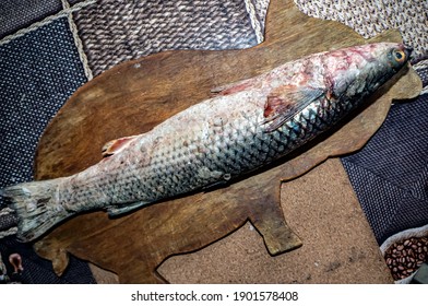 Defrosted Mullet Fish With The Latin Name Mugilidae On A Cutting Board