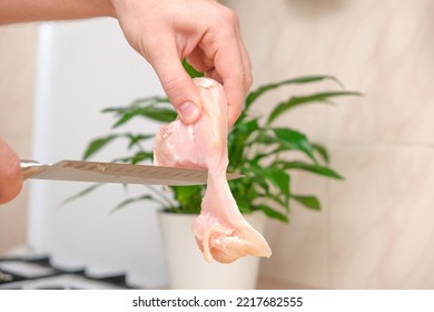 Defrosted Raw Chicken Fillet On Cutting Board. Slicing Fresh Raw Chicken Breast With Sharp Knife For Cooking Chopped Chicken Cutlets On A Bamboo Wooden Cutting Board For Slicing. Kitchen Knife Test.