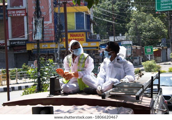 Dehradun, Uttarakhand/India- August 15 2020:\
policemen sanitizing vehicles & buildings to control corona\
virus infection.