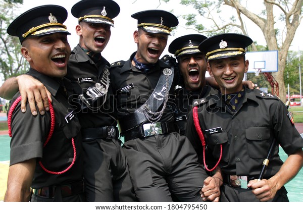 Dehradun, Uttarakhand/India-AUGUST 15 2020: Indian army\
cadets celebrate after their graduation ceremony at the Indian\
military academy Dehradun . Five to seven officers cheering in\
front of camera  