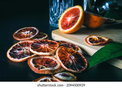 Dehydrated Citrus Fruit Oranges Blood Orange And Lemon Dragon Fruit Cocktail In A Glass With Ice Spash Tonic Black Background Product Photography Citrus Wheels Nightlife