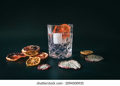 Dehydrated Citrus Fruit Oranges Blood Orange And Lemon Dragon Fruit Cocktail In A Glass With Ice Spash Tonic Black Background Product Photography Citrus Wheels Nightlife