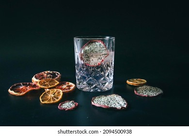 Dehydrated Citrus Fruit Oranges Blood Orange And Lemon Dragon Fruit Cocktail In A Glass With Ice Spash Tonic Black Background Product Photography Citrus Wheels Nightlife