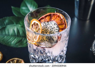 Dehydrated Citrus Fruit Oranges Blood Orange And Lemon Dragon Fruit Cocktail In A Glass With Ice Spash Tonic Black Background Product Photography Citrus Wheels Nightlife