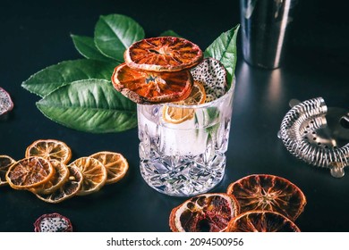 Dehydrated Citrus Fruit Oranges Blood Orange And Lemon Dragon Fruit Cocktail In A Glass With Ice Spash Tonic Black Background Product Photography Citrus Wheels Nightlife