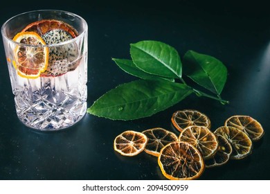 Dehydrated Citrus Fruit Oranges Blood Orange And Lemon Dragon Fruit Cocktail In A Glass With Ice Spash Tonic Black Background Product Photography Citrus Wheels Nightlife