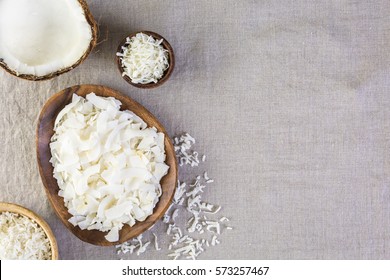 Dehydrated Coconut Flakes In Wooden Bowl.