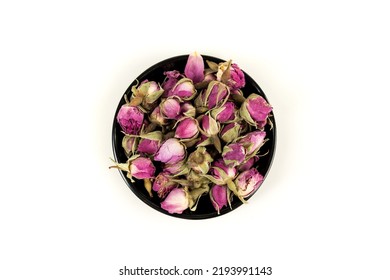 Dehydrated Pink Rose Buds In A Black Bowl Top Down View Isolated Over White