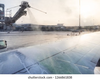 de-icing of aircraft wing by liquid reagent in Sheremetyevo airport in winter evening