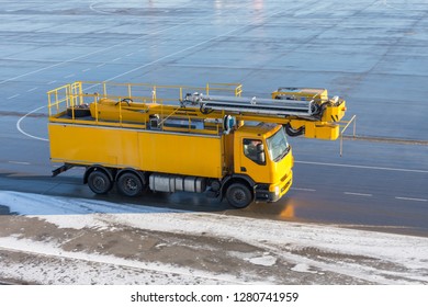Deicing yellow car on the airfield at the airport