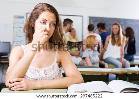 Dejected lonely student sits at her desk