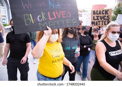 DeLand, Florida / USA - June 2, 2020: George Floyd Remembered at Peaceful Protest in Downtown DeLand, Volusia County, Florida. Black lives matter protesters holding a signs.
