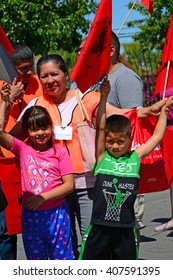 DELANO, CA - APRIL 17, 2016: Two Young Children Are Enjoying Their Participation In Today's March By The Members Of The United Farm Workers For Agricultural Workers' Rights.