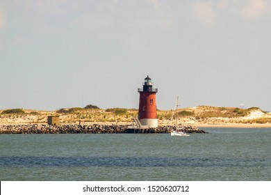 Delaware Breakwater East End Lighthouse And Sailboat Off The Coast Of Lewes, Delaware In Lewes.