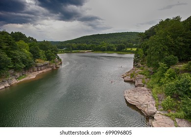 Delaware River Narrows Along New York/Pennsylvania Border With Lush Foliage-filled Banks On Both Sides & In Background