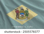 Delaware US state flag depicted on folded wavy fabric of old cloth close up