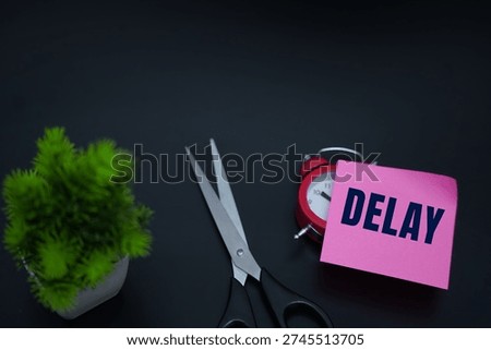 Delay message on pink note with scissors and plant.Business delay and time loss concept