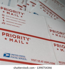 DELCAMBRE, L.A. / USA - MAY 08, 2019: Priority Mail Letter Box, USPS White, Flat, Cardboard Boxes For Shipping Priority Mail.