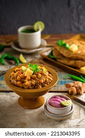 Delectable Chole Kulcha With Butter And Coriander Garnishing On Top And  Green Chutney On Side