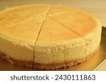 Delectable creamy baked cheesecake with a slice cut from whole cake