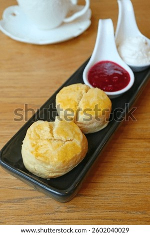 Delectable Scones with Raspberry Jam and Whipped Cream