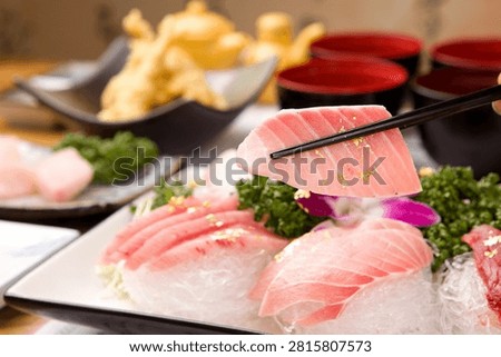 A delectable serving of tuna sashimi, adorned with gold flakes.