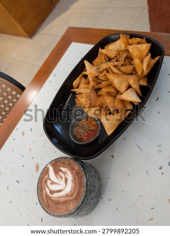 A delectable spread of snacks and coffee on a trendy caf? table.