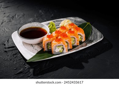 Delectable sushi rolls adorned with vibrant salmon roe, served with soy sauce on a modern plate - Powered by Shutterstock