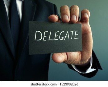 Delegate Sign In The Hands Of A Businessman. Delegation Concept.