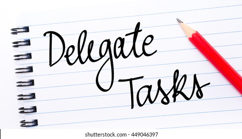Delegate Tasks written on notebook page with red pencil on the right