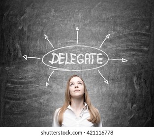 Delegating concept with thoughtful businesswoman on chalkboard background