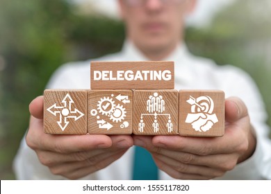 Delegating Leadership Business Organization Concept. Leader arranging wooden blocks with delegate concept.