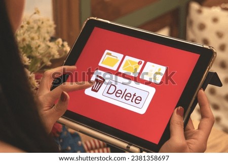 Deleting documents, junk mail, electronic messages or personal information in tablet system. Concepts of technology and document management from online platforms