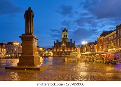 Delft City Hall and Delft Market Square Markt with Hugo de Groot Monument in the evening. Delft, Netherlands