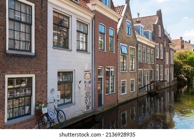 Delft, The Netherlands, June 7, 2021; Historic houses along the canal in the medieval city of Delft.