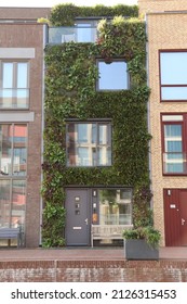 Delft, the Netherlands - October 2021: modern row house with green facade of more than 4000 plants in Graaf Floriskade, dutch city Delft by FARO Architects