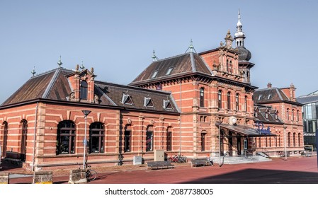 Delft, The Netherlands, October 9, 2021: The old station of Delft, today's Pavarotti restaurant next to the new station and the city hall of Delft, the Netherlands.