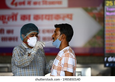 Delhi, India - 06-02-2021 - A Medical Worker Takes A Swab Sample  For A Reverse Transcription Polymerase Chain Reaction (RT-PCR) Test For Covid-19 During Random Testing At Railway Station In Delhi.