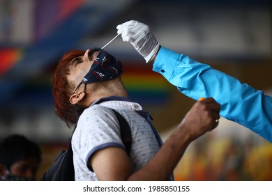 Delhi, India - 06-02-2021 - A Medical Worker Takes A Swab Sample  For A Reverse Transcription Polymerase Chain Reaction (RT-PCR) Test For Covid-19 During Random Testing At Railway Station In Delhi.