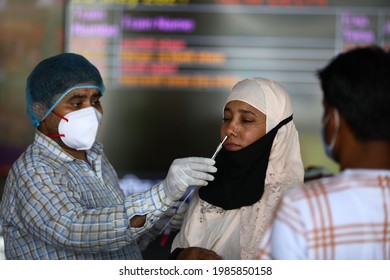 Delhi, India - 06-02-2021 - A Medical Worker Takes A Swab Sample  For A Reverse Transcription Polymerase Chain Reaction (RT-PCR) Test For Covid-19 During Random Testing At Railway Station In Delhi.