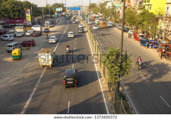 Delhi/ India - 09.02.2019:\
Indian city streets with modern traffic and pedestrians, aerial\
view