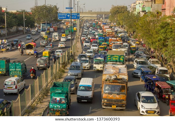 Delhi/ India - 09.02.2019: Indian\
traffic of diverse freight and urban transport, aerial\
view