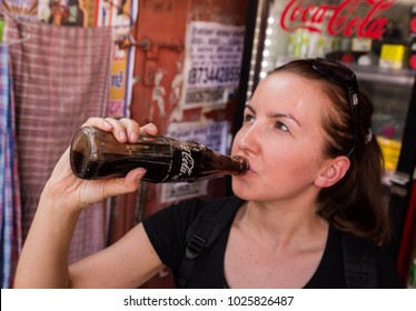 DELHI INDIA 10.02.2018 - Woman Drinking A Coca Cole In An Old Retro Bottle